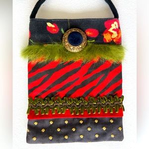 Fabric and ribbon trimmed crossbody purse.